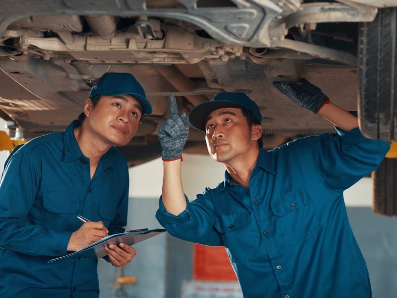 service-workers-checking-car-bottom.jpg